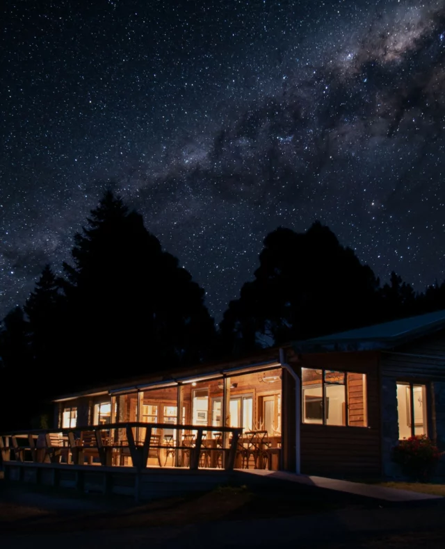 The Koru Hills lodge and casino glowing beneath the Milky Way